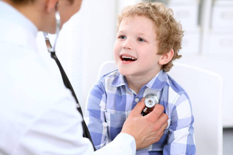 Pediatric Doctor examining a child patient by stethoscope.